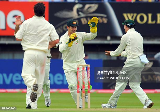 Australian wicket keeper Graham Manou celebrates dismissing England batsman Andrew Strauss on the fourth day of the third Ashes cricket test between...