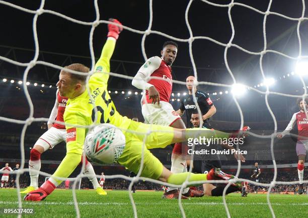 Danny Welbeck scores Arsenal's goal past Joe Hart of West Ham during the Carabao Cup Quarter Final match between Arsenal and West Ham United at...