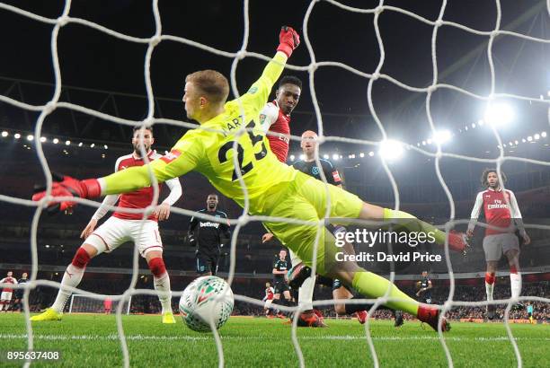 Danny Welbeck scores Arsenal's goal past Joe Hart of West Ham during the Carabao Cup Quarter Final match between Arsenal and West Ham United at...