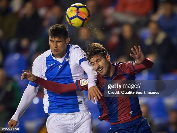 Jose Gomez Campana of Levante competes for the ball with Ezequiel Munoz of Leganes during the La Liga match between Levante and Leganes at Ciutat de...