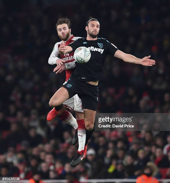 Calum Chambers of Arsenal challenges Andy Carroll of West Ham during the Carabao Cup Quarter Final match between Arsenal and West Ham United at...
