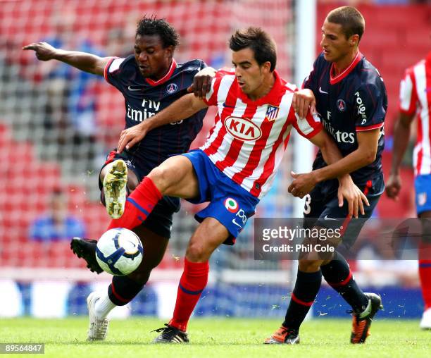 Jose Manuel Jurado of Athletico holds off the challenges from Stephane Sessegnon and Jeremy Clement of PSG during the Emirates Cup match between...