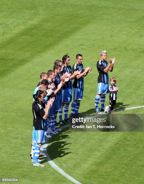 Newcastle players observe a minute's applause in memory of Sir Bobby Robson prior to the pre-season friendly match between Dundee United and...