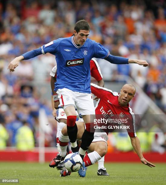 Arsenal's French defender Mikael Silvestre vies with Rangers' Northern Irish striker Kyle Lafferty during the Emirates Cup competition at the...