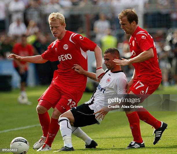 Benjamin Koehler of Frankfurt is surrounded by Steffen Haas and Stafen Zinnow of Offenbach during the DFB Cup first round match between Kickers...
