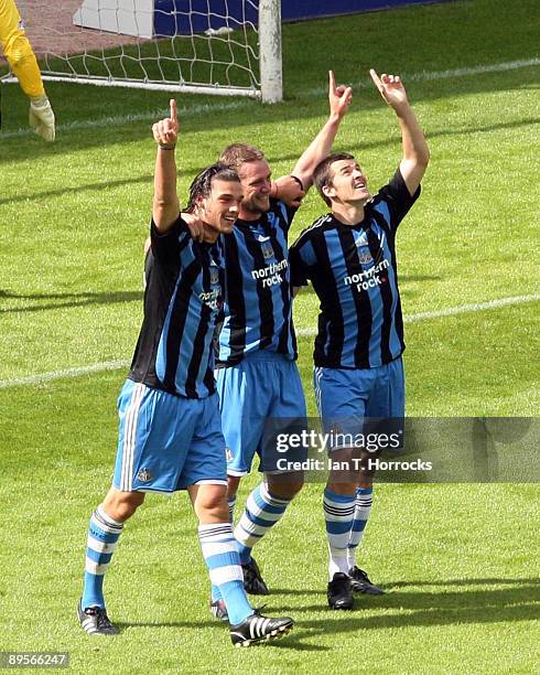 Andy Carroll, Kevin Nolan and Joey Barton of Newcastle United point skyward in remembrance of the late Sir Bobby Robson as they celebrate Carroll's...