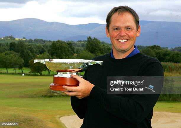 Jamie McLeary of Scotland is presented with the trophy after winning the Scottish Hydro Challenge at the Macdonald Spey Valley Golf Course on August...