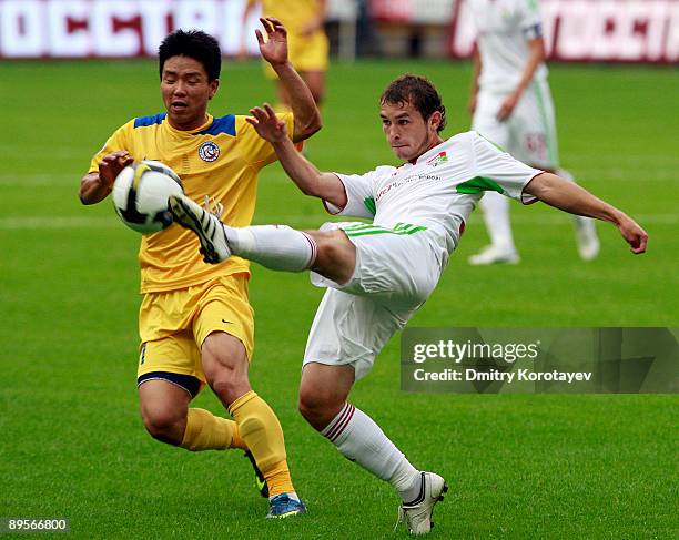 Kirill Pavlov of FC Lokomotiv Moscow battles for the ball with Hong Yong-Jo of FC Rostov Rostov-on-Don during the Russian Football League...