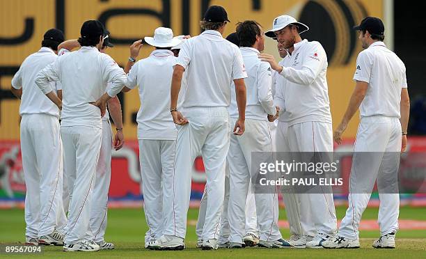 England's Andrew Flintoff congratulates bowler Graeme Swann after he dismissed Australian batsman Ricky Ponting for 5 runs on the fourth day of the...