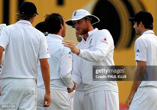 England's Andrew Flintoff congratulates bowler Graeme Swann after he dismissed Australian batsman Ricky Ponting for 5 runs on the fourth day of the...