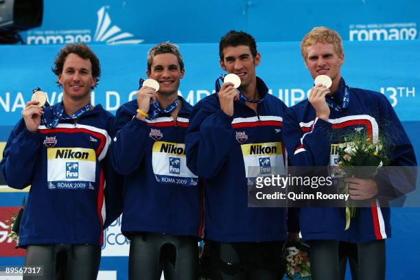 Aaron Peirsol, Eric Shanteau, Michael Phelps and David Walters of the United States receive the gold medal during the medal ceremony for the Men's 4x...