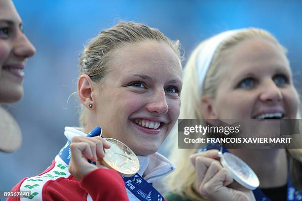 Gold medalist Hungary's Katinka Hosszu , silver medalist Zimbabwe's Kirsty Coventry and bronze medalist Australia's Stephanie Rice pose on the podium...