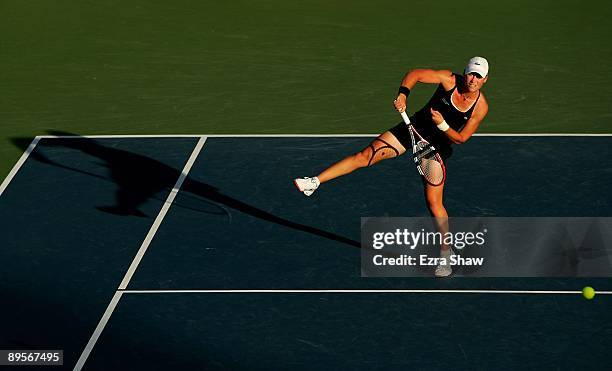 Samantha Stosur of Australia hits an overhead return to Marian Bartoli of France during their semifinal match on Day 6 of the Bank of the West...