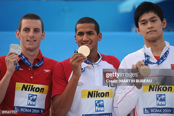 Gold medalist Tunisia's Oussama Mellouli , silver medalist Canada's Ryan Cochrane and bronze medalist China's Yang Sun celebrate on the podium of the...