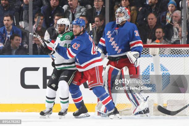 Ondrej Pavelec of the New York Rangers tends the net as Brendan Smith defends against Gemel Smith of the Dallas Stars at Madison Square Garden on...