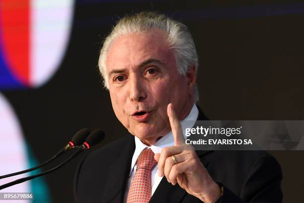 Brazilian President Michel Temer delivers a speech during the Order of Cultural Merit Ceremony at the Planalto Palace in Brasilia on December 19,...