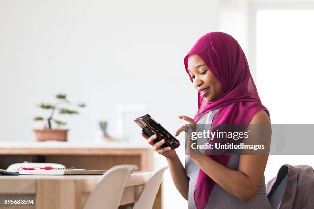 business woman answering phone - pregnant muslim stock pictures, royalty-free photos & images