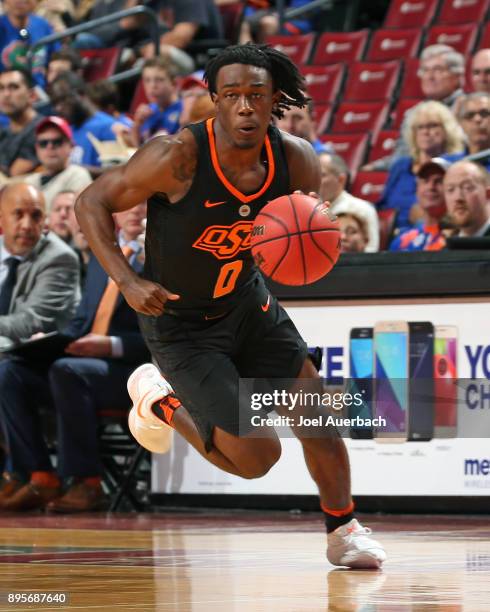 Brandon Averette of the Oklahoma State Cowboys brings the ball up court against the Florida State Seminoles during the MetroPCS Orange Bowl...