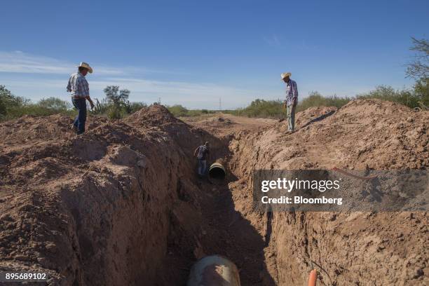 Members of the Tropa Yoemia stand at the location where a section of the Sempra Energy gas pipeline was extracted by the Yaqui tribe in the village...