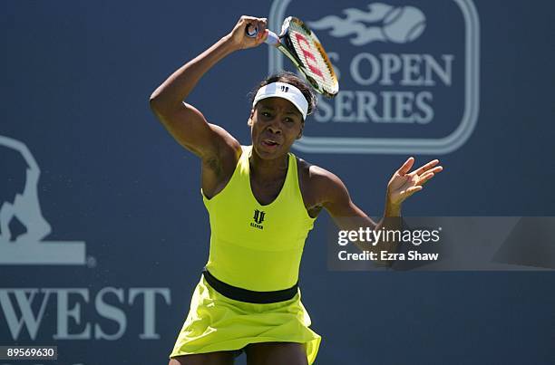 Venus Williams returns a shot to Marion Bartoli of France during the final match of the Bank of the West Classic August 2, 2009 in Stanford,...