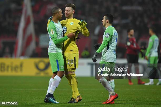 Marcel Tisserand and Goalkeeper Max Gruen of Wolfsburg celebrate after the final whistle of extra time of the DFB Cup match between 1. FC Nuernberg...