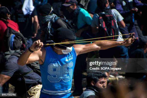 Demonstrator takes aim. Protestors from various left-wing groups attacked police after a largely peaceful demonstration outside the nation's Congress...