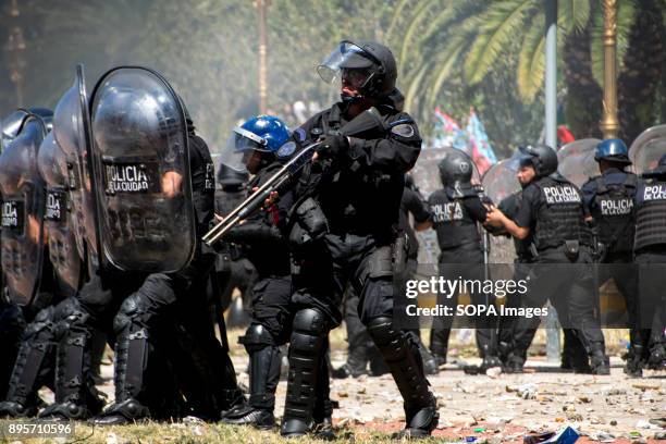 Police officer eyes his target before raising his weapon. Protestors from various left-wing groups attacked police after a largely peaceful...