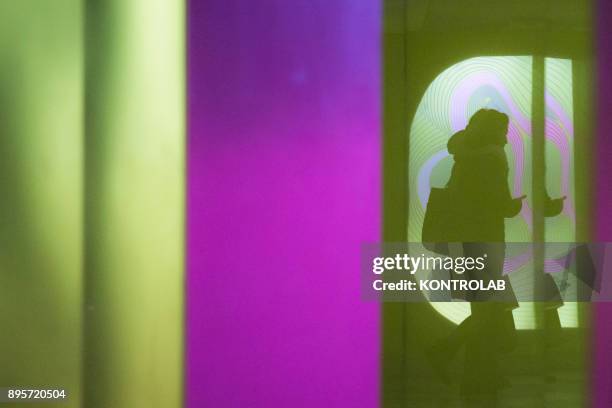 The reflection of a woman inside one of underground metro stations in Naples. The Neapolitan Underground Line1 is called "Art Station Line".