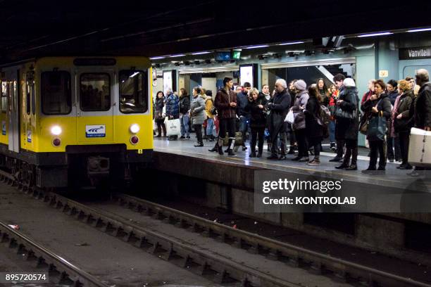 People wait for the train inside one of underground metro stations in Naples. The Neapolitan Underground Line1 is called "Art Station Line".