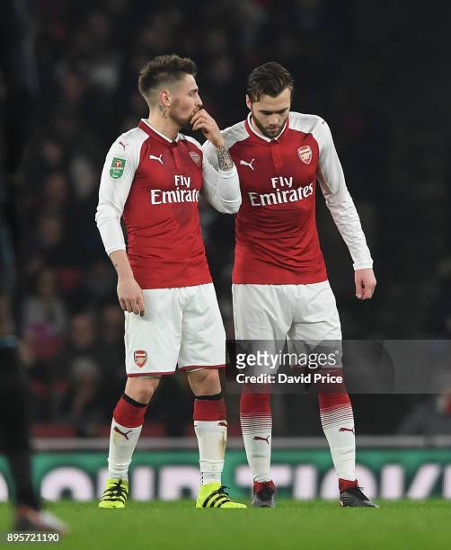 Mathieu Debuchy gives Calum Chambers of Arsenal some instructions during the Carabao Cup Quarter Final match between Arsenal and West Ham United at...