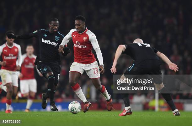 Danny Welbeck of Arsenal takes on James Collins and Pedro Obiang of West Ham during the Carabao Cup Quarter Final match between Arsenal and West Ham...