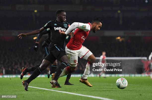 Theo Walcott of Arsenal takes on Domingos Quina of West Ham during the Carabao Cup Quarter Final match between Arsenal and West Ham United at...