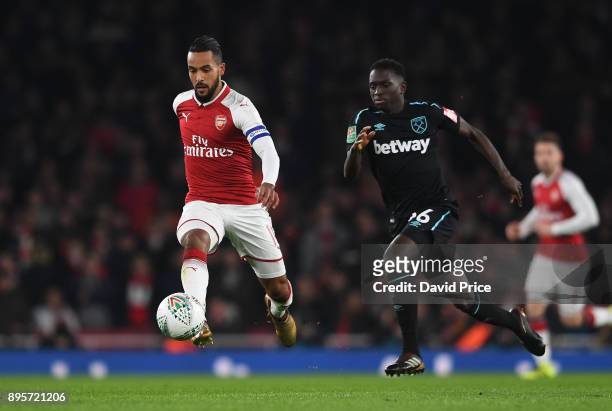 Theo Walcott of Arsenal takes on Domingos Quina of West Ham during the Carabao Cup Quarter Final match between Arsenal and West Ham United at...