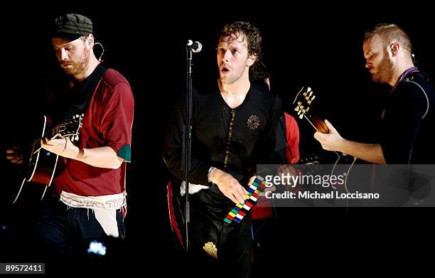 Musicians Jonny Buckland, Chris Martin and Guy Berryman of Coldplay perform on stage during the 2009 All Points West Music & Arts Festival at Liberty...