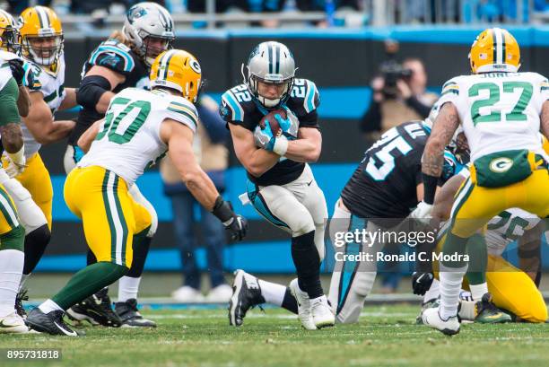 Running back Christian McCaffrey of the Carolina Panthers carries the ball against the Green Bay Packers during a NFL game at Bank of America Stadium...