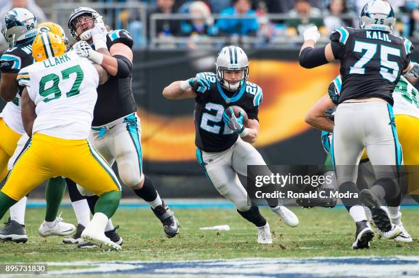 Running back Christian McCaffrey of the Carolina Panthers carries the ball against the Green Bay Packers during a NFL game at Bank of America Stadium...