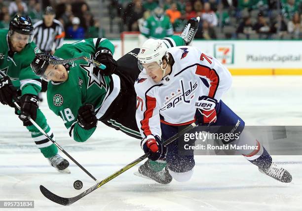 Oshie of the Washington Capitals skates the puck against Tyler Pitlick of the Dallas Stars in the first period at American Airlines Center on...