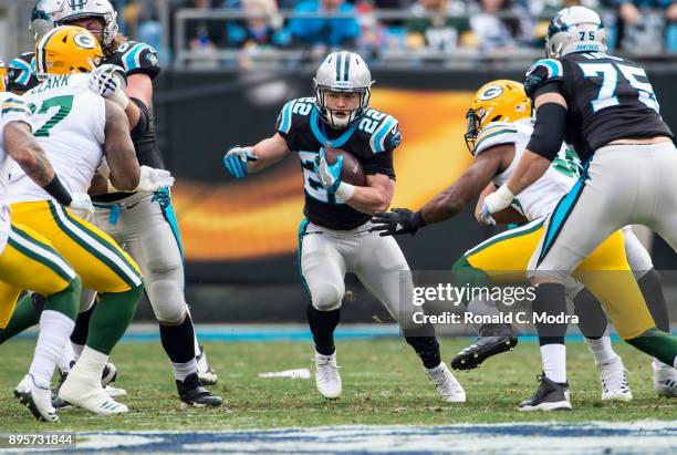 Running back Christian McCaffrey of the Carolina Panthers carries the ball against the Green Bay Packers during a NFL game at Bank of America Stadium...