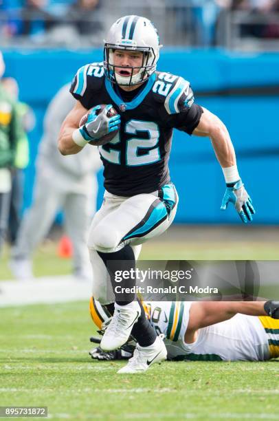 Running back Christian McCaffrey of the Carolina Panthers carries the ball against the Green Bay Packers during a NFL game at Bank of America Stadium...
