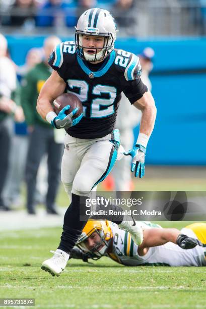 Running back Christian McCaffrey of the Carolina Panthers carries the ball against the Green Bay Packers during a NFL game at Bank of America Stadium...