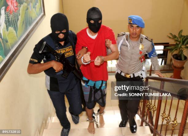 Indonesian police escort US prisoner Christian Beasley to a press conference at a police station in Badung regency, on Indonesia's resort island of...