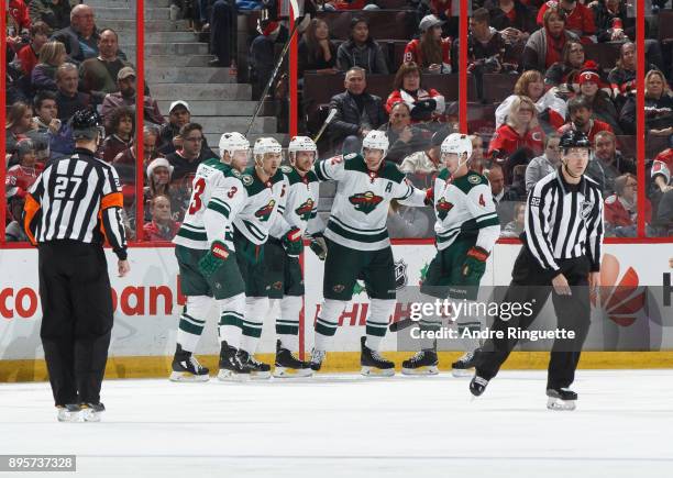 Jonas Brodin of the Minnesota Wild celebrates a third period goal against the Ottawa Senators with teammates Charlie Coyle, Nino Niederreiter, Eric...