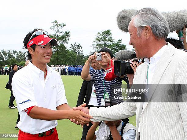 Ryo Ishikawa of Japan and Isao Aoki shake hands after Ishikawa won the San Chlorella Classic at Otaru Country Club on August 2, 2009 in Otaru, Japan.