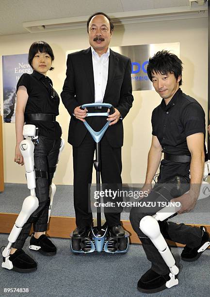 Japanese auto giant Toyota Motor senior general manager Soya Takagi rides a personal transport assistance robot called "Winglet", while Cyberdyne...