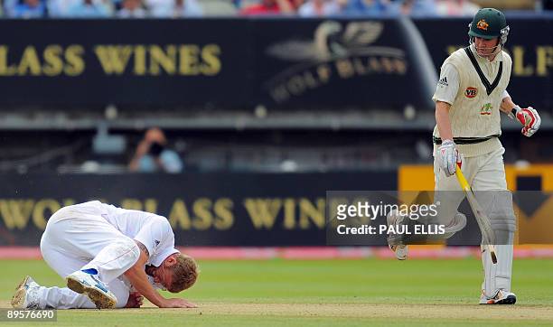 Australian batsman Michael Clarke looks down as England bowler Andrew Flintoff falls to the ground while bowling on the final day of the third Ashes...