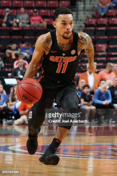 Chris Chiozza of the Florida Gators dribbles the ball against the Clemson Tigers during the MetroPCS Orange Bowl Basketball Classic on December 16,...