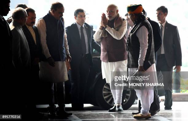 Indian Prime Minister Narendra Modi greets upon his arirval for the Bharatiya Janata Party parliamentary meeting in New Delhi on December 20, 2017....
