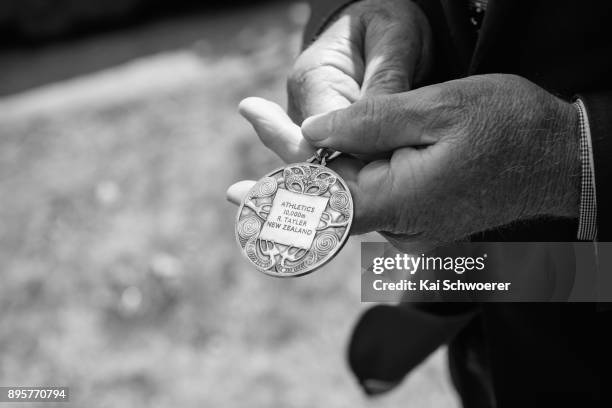 Former New Zealand runner Dick Tayler holds his 1974 Christchurch Commonwealth Games gold medal during a Commonwealth Games Queens Baton Relay...