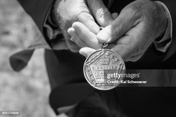 Former New Zealand runner Dick Tayler holds his 1974 Christchurch Commonwealth Games gold medal during a Commonwealth Games Queens Baton Relay...