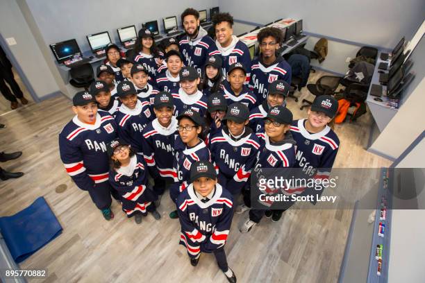 Kids pose for a photo in the newly renovated WHEDco Youth Leadership Center as the NHL and the New York Rangers partner with WHEDco and the Garden of...